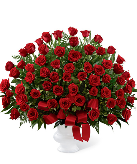 Dozens of ruby-red roses arranged in a classic urn will create an outstanding show of respect for a beloved friend, family member or business associate.