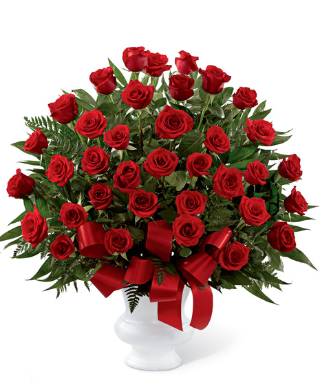 Dozens of ruby-red roses arranged in a classic urn will create an outstanding show of respect for a beloved friend, family member or business associate.